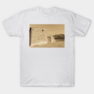 Old stone building with dilapidated wooden doors T-Shirt